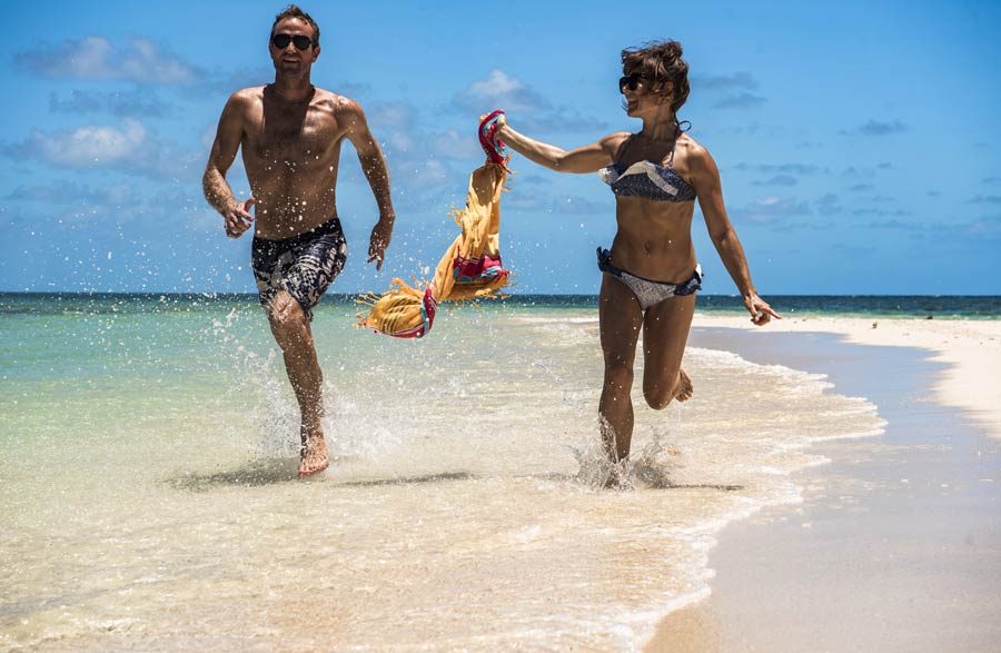 Sailaway-couple-running-on-Mackay-Coral